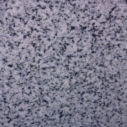 Halayeb granite slab face, photographed for the factory catalog — mid-toned grey overall.