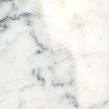 Calacatta Altissimo marble slab face, photographed for the factory catalog — near-white warm beige overall.