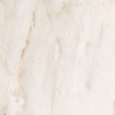 Cremo Delicato marble slab face, photographed for the factory catalog — near-white amber overall.