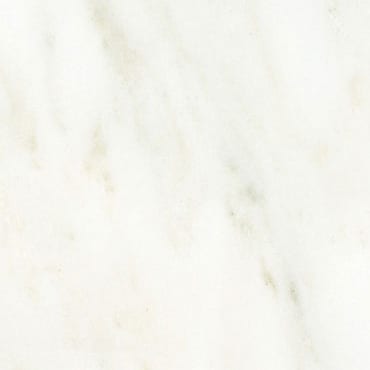 Dionyssos Pentelicon White marble slab face, photographed for the factory catalog — near-white gold overall.