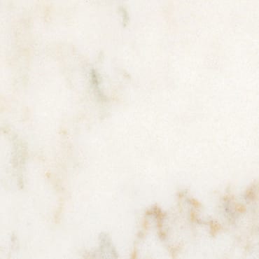 Imperial Danby marble slab face, photographed for the factory catalog — near-white gold overall.